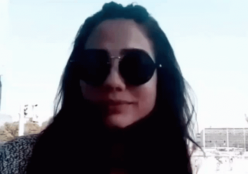 a woman in a black shirt with sunglasses