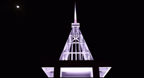 this is a building with a spire at night