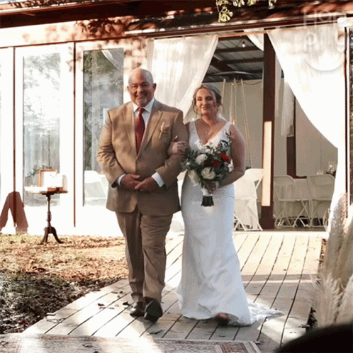 man and woman at wedding standing under chute on deck