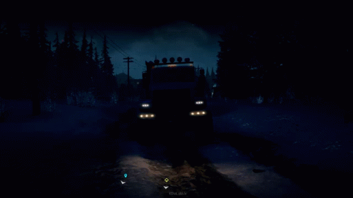 there is a truck driving through the dark