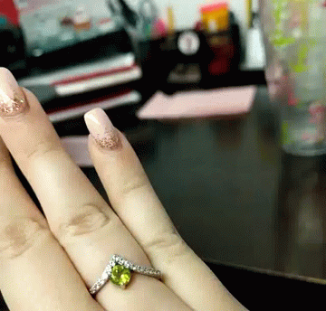 a person's hand with a diamond ring on it