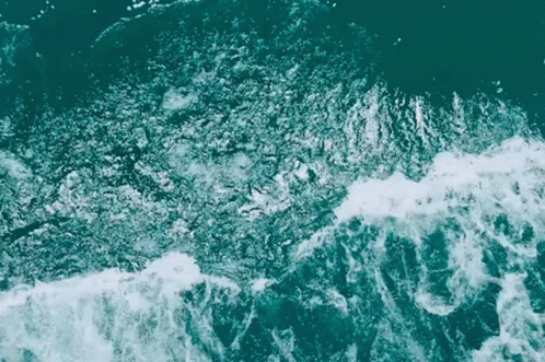 a surfer rides a wave while on top of an ocean wave