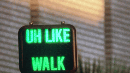 an uno like walk sign sitting outside on the side of a building