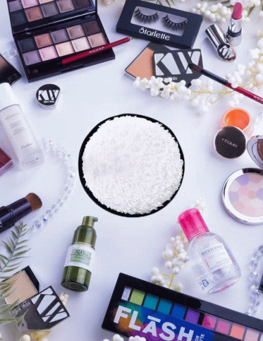 several cosmetics and make up products laid out on a white surface