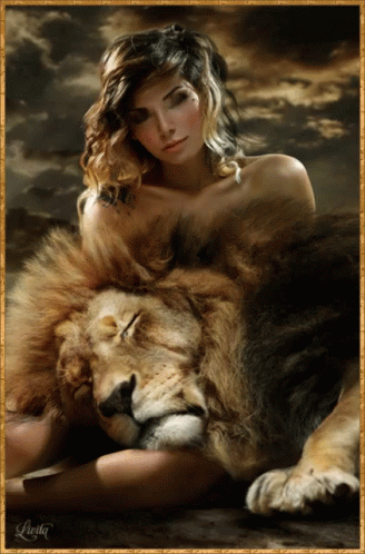 a beautiful woman poses next to a lion in blue