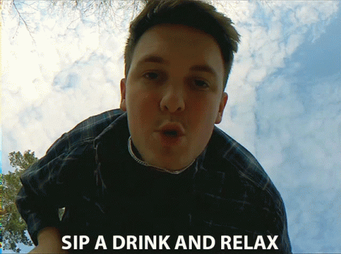 a guy posing with a drink and relaxation