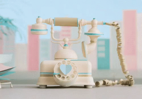 an old fashioned toy phone sitting on top of a table