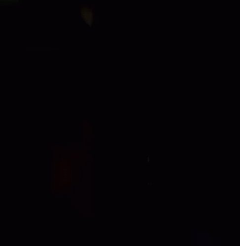 a clock in the dark on a dark background