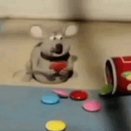 there is a paper mouse standing next to a container of pills
