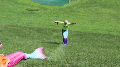 two colorful mermaid tails with their arms outstretched