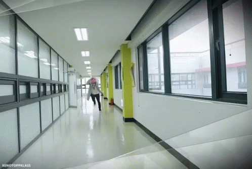 an empty hallway leading to two floors with glass partitions