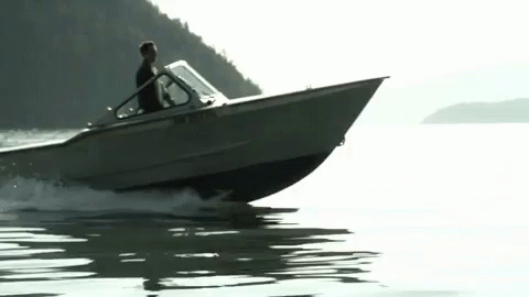 the man is driving his boat through the water