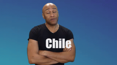 a blue man stands with his arms crossed wearing a shirt with the word chile printed on it