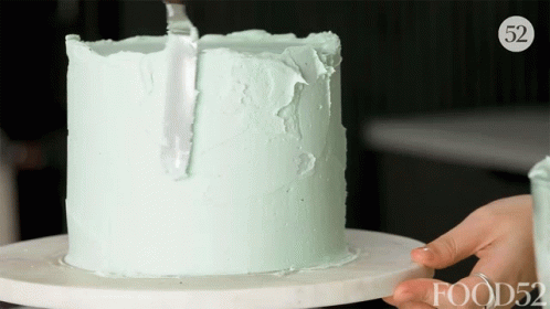 a person placing candles on top of a cake