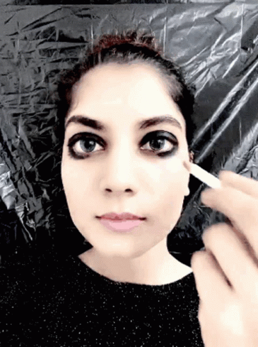 an image of a woman getting her make up