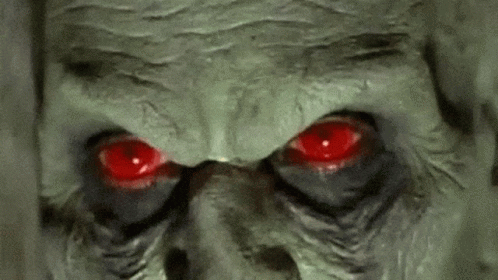 an evil looking man with blue eyes is seen in this image