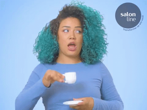 a person with blue makeup holding a cup and plate