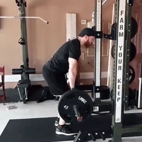the man is squatting in the gym