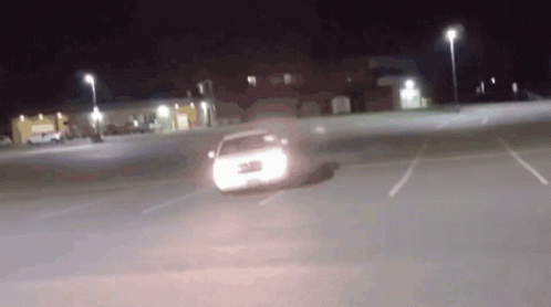 a car is driving at night on the street