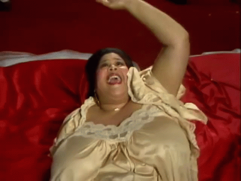a plus size woman in yellow is laying on a purple blanket