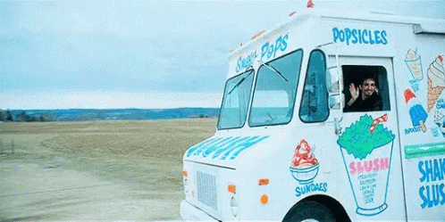 an ice cream truck near a body of water