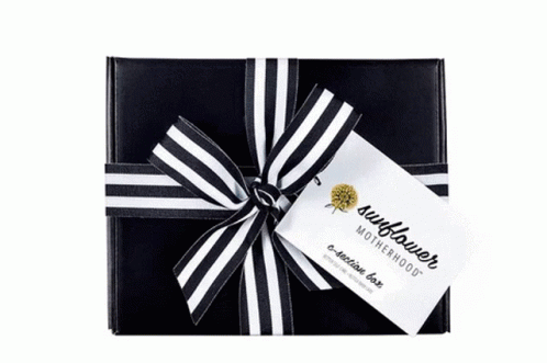 an open gift box with a black and white stripe bow