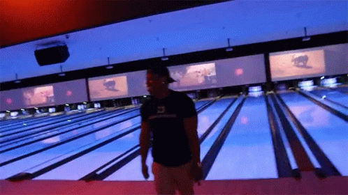 a person standing in front of a bowling alley