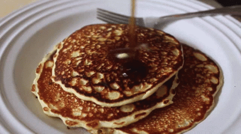 a couple of pancakes on a plate that is sitting on the table