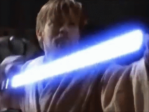a boy holding a glowing light saber