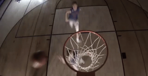 a basketball hoop with a blurry po of a player dunking the basketball