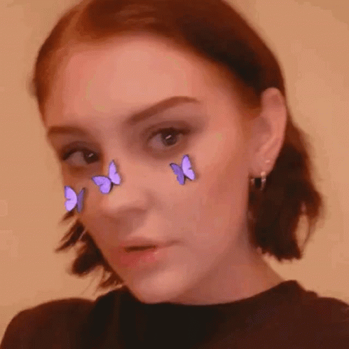 an image of a girl with glowing erflies on her face