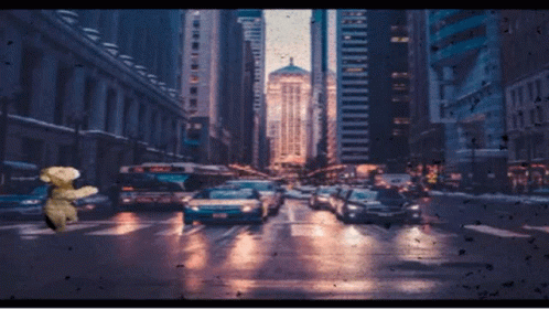 a rainy city street in new york, ny with people crossing