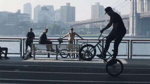 a man on a bicycle being hed past on the bridge