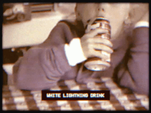 the computer is sitting on a desk, it has an ad for white lighting drink