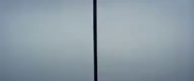 the back and side view of a tall white refrigerator