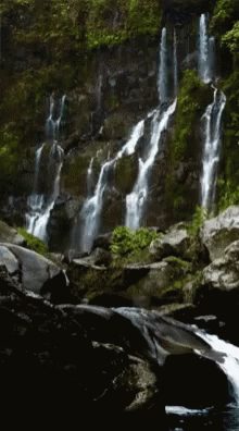 a large waterfall with lots of rocks around it