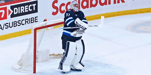 a professional hockey player making a save on an ice rink