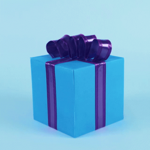 a large yellow wrapped gift with a purple ribbon on it