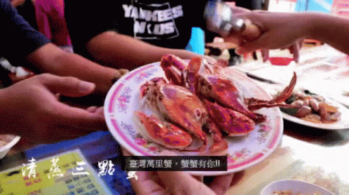 a close up of a plate with purple crab on it