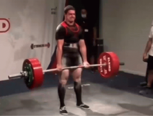 a man in a black and white outfit lifts a barbell