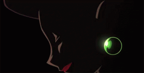 the green glowing eyes and tail on this cat is glowing