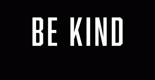 a white sign with the words be kind in it