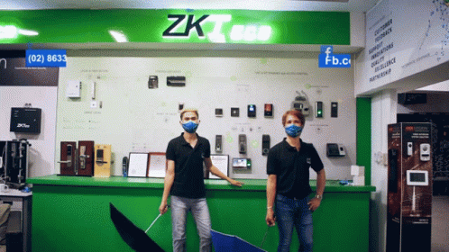 two men wearing face paint stand in front of an electronic device store
