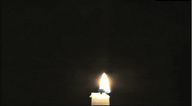 a single candle is glowing in the dark