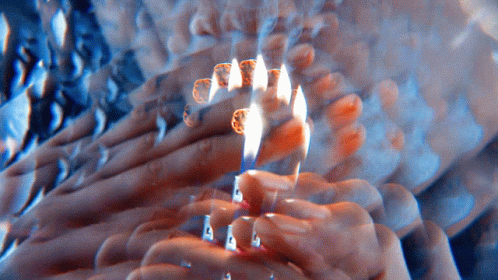 a candle burns brightly in the middle of the image