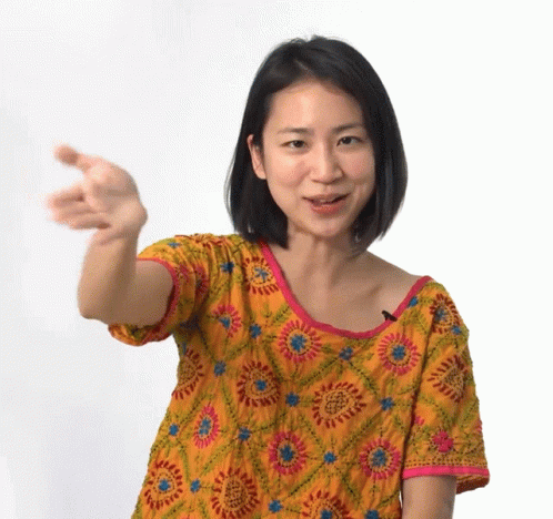asian woman in a blue dress holding out two fingers