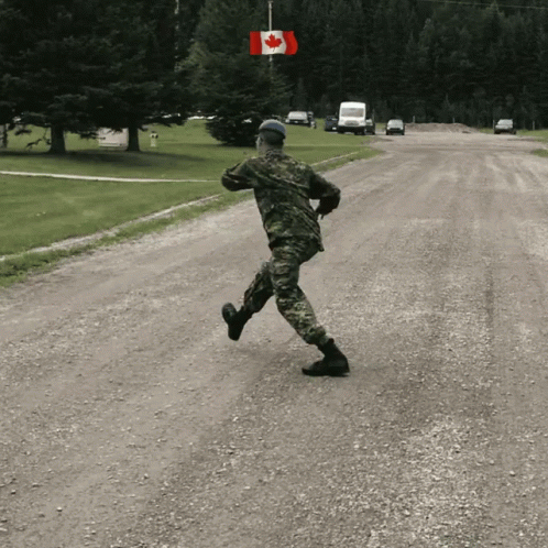 a soldier running down a country road