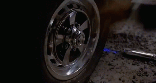 the tire of a car with a dynamite lighter sticking out of it