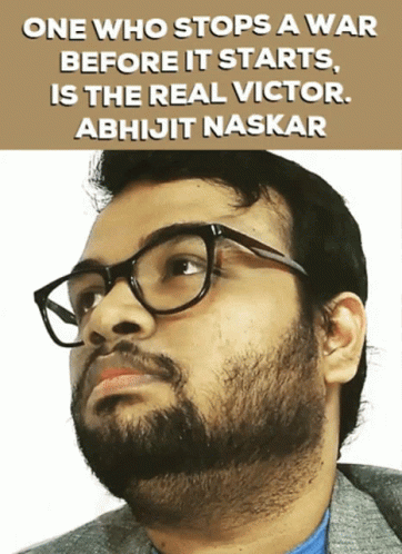 a man with glasses on looking into the distance and a sign on the back ground saying, one who stops a war before it starts is the real victory abhigt naskar