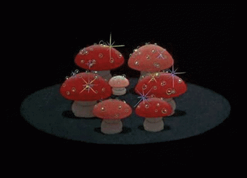 three little blue mushrooms with sprinkles on their backs